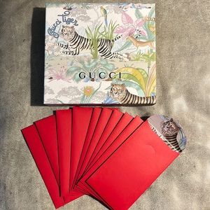 Gucci tiger box with 10 red envelopes and a pen.